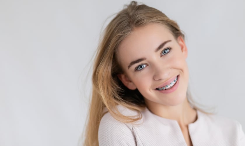 Girl with braces smiling brightly.