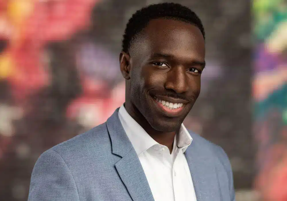 A man wearing a suit smiling