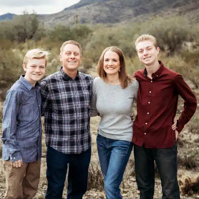 Three men and one women standing on a valley of green surroundings one of them is a Doctor from DDS Valley Pediatric dentists