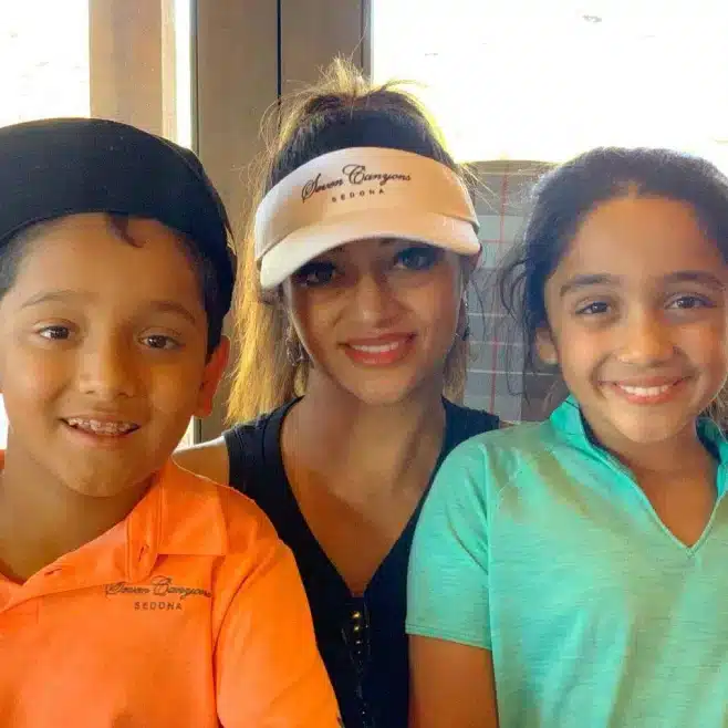 DR. Rashmi Bhatnagar, DMD from Bella Vista Dental standing with two kids.