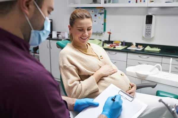 orthodontist consulting treatment to pregnant woman