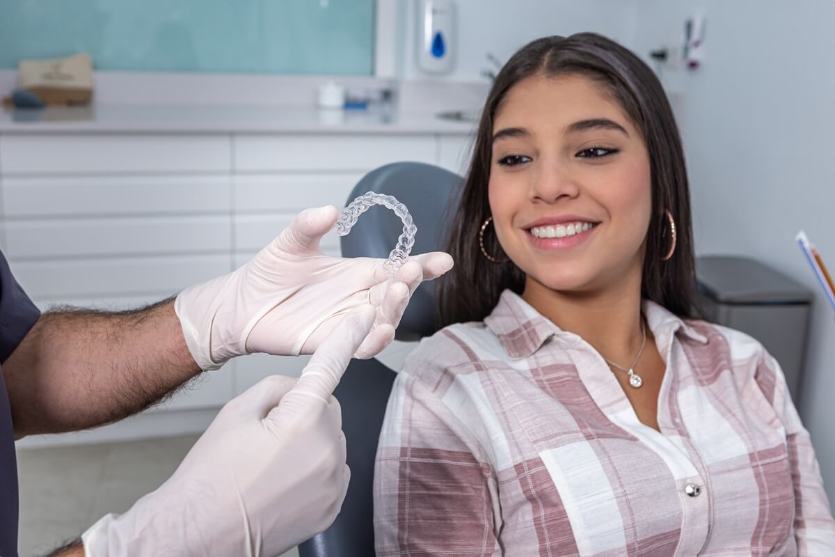 dentist showing woman how Invisalign work