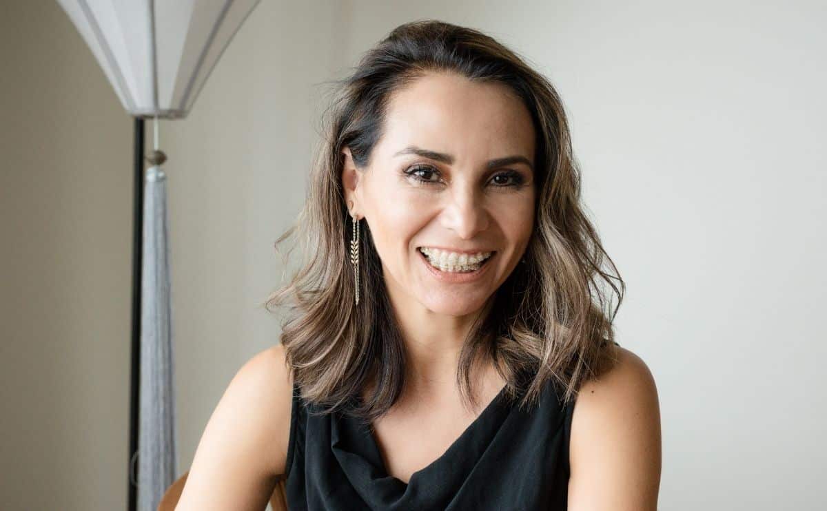 A man in Suit standing and smiling after Invisalign treatment in Phoenix